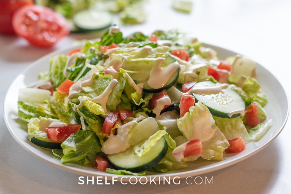 Image d'une salade de jardin avec de la laitue, des concombres, des tomates et de la sauce ranch. - Étagère Cuisine